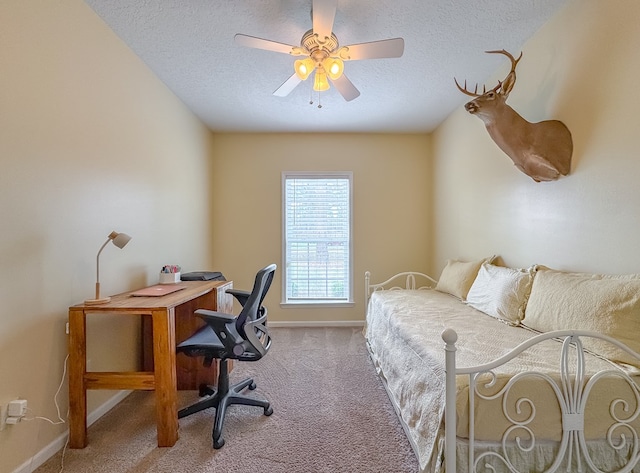 bedroom with ceiling fan, a textured ceiling, and light colored carpet