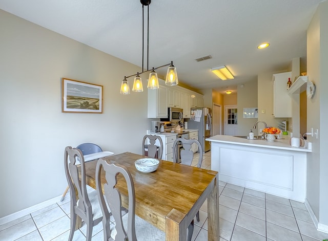 dining room with light tile patterned flooring and sink