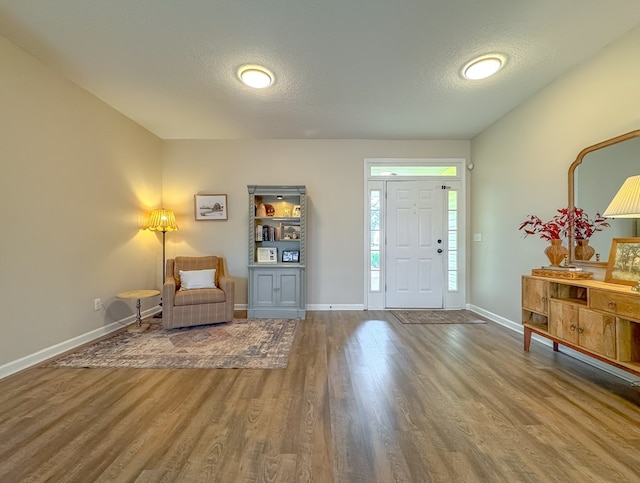 entrance foyer with hardwood / wood-style flooring and a textured ceiling