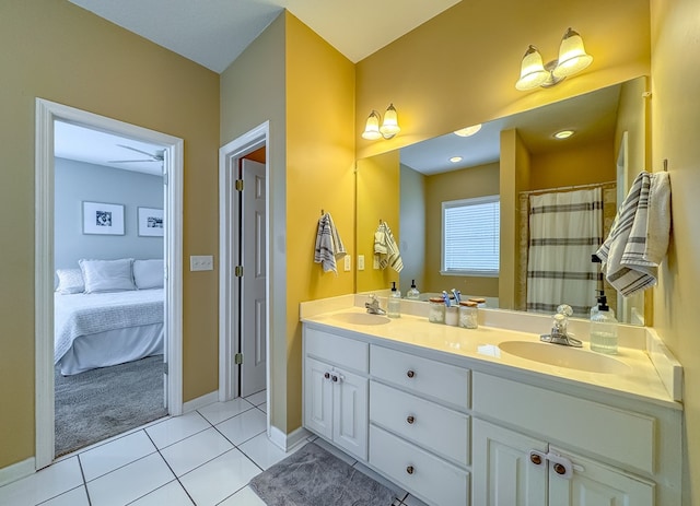 bathroom featuring tile patterned floors, vanity, and curtained shower