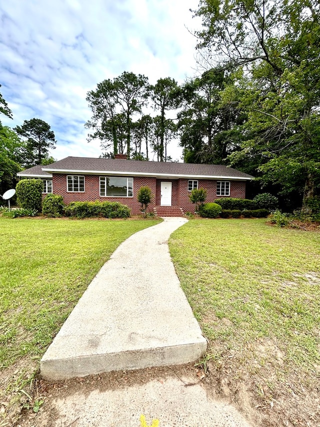 356 E Main St, Colquitt, GA 39837 - ranch-style home with a front lawn, brick siding, and driveway