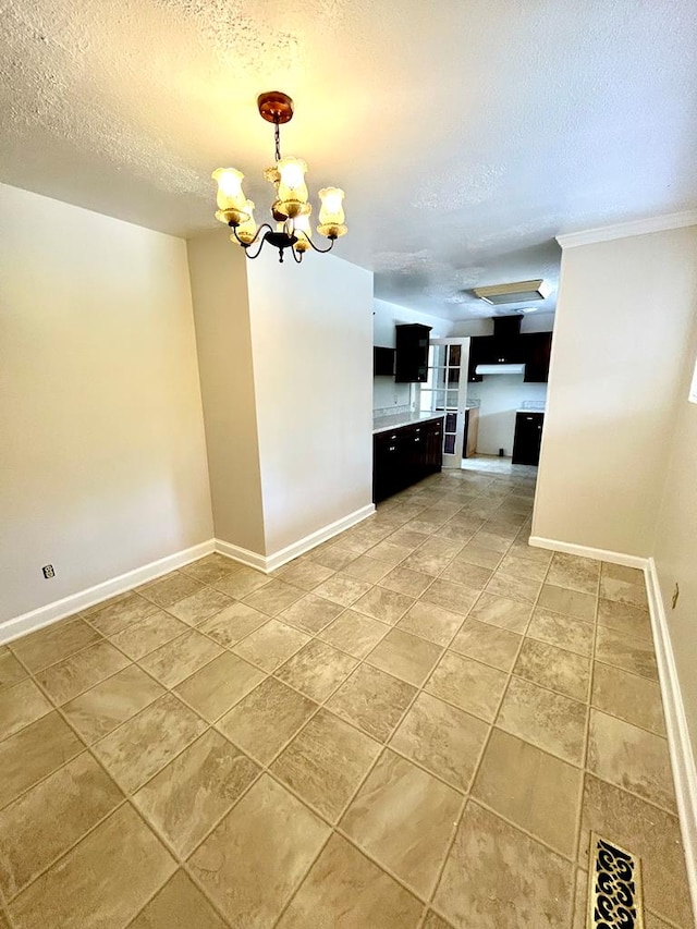 356 E Main St, Colquitt, GA 39837 - kitchen with a textured ceiling, a chandelier, baseboards, crown molding, and decorative light fixtures