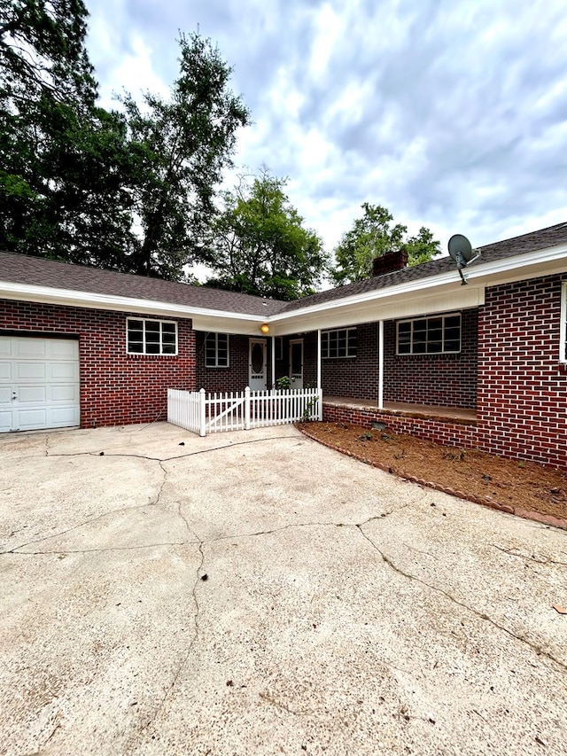 356 E Main St, Colquitt, GA 39837 - view of front facade with brick siding, fence, an attached garage, and concrete driveway