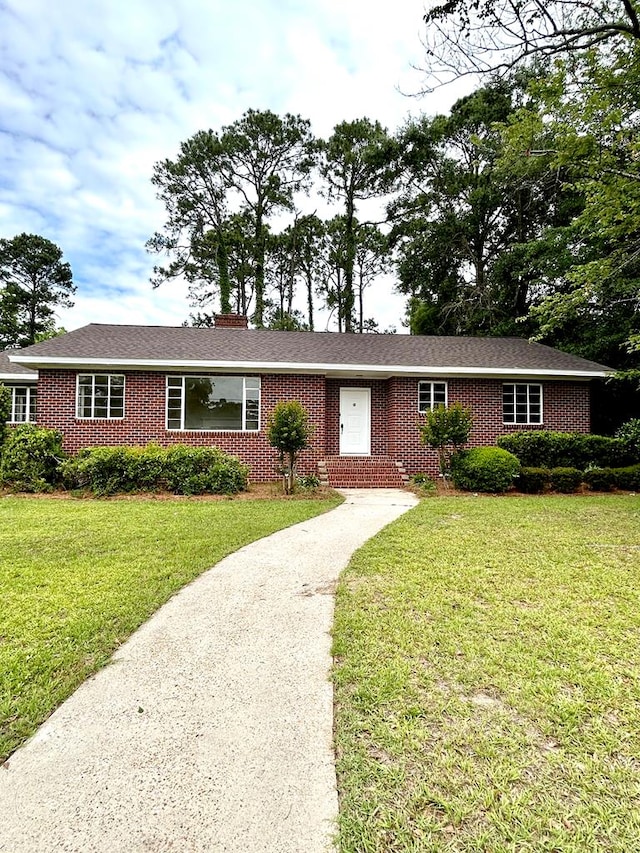 356 E Main St, Colquitt, GA 39837 - ranch-style house with brick siding, a front lawn, and driveway