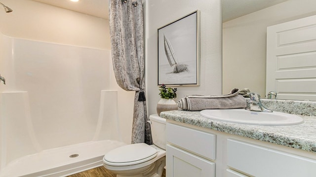 bathroom with a shower with curtain, a textured ceiling, toilet, vanity, and hardwood / wood-style flooring