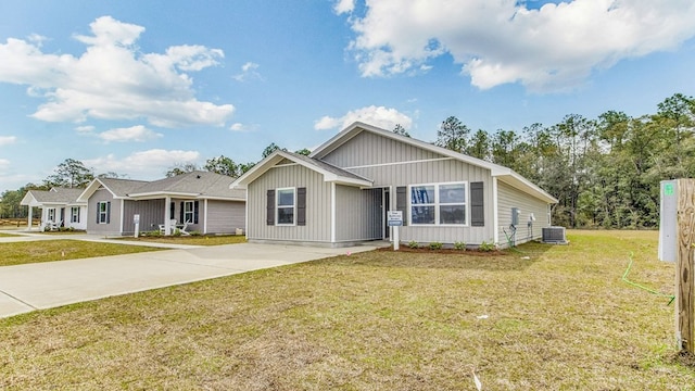 view of front of house featuring central AC and a front yard