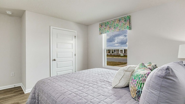 bedroom with hardwood / wood-style floors