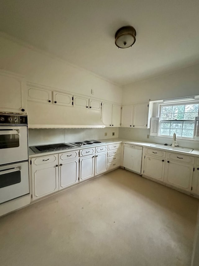 kitchen with light countertops, white appliances, white cabinets, and a sink