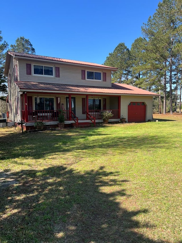 view of front of property featuring a porch, a front yard, driveway, and a garage