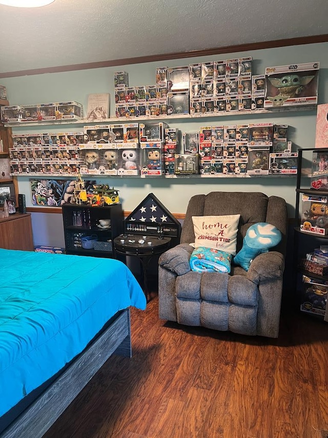 bedroom featuring a textured ceiling and wood finished floors