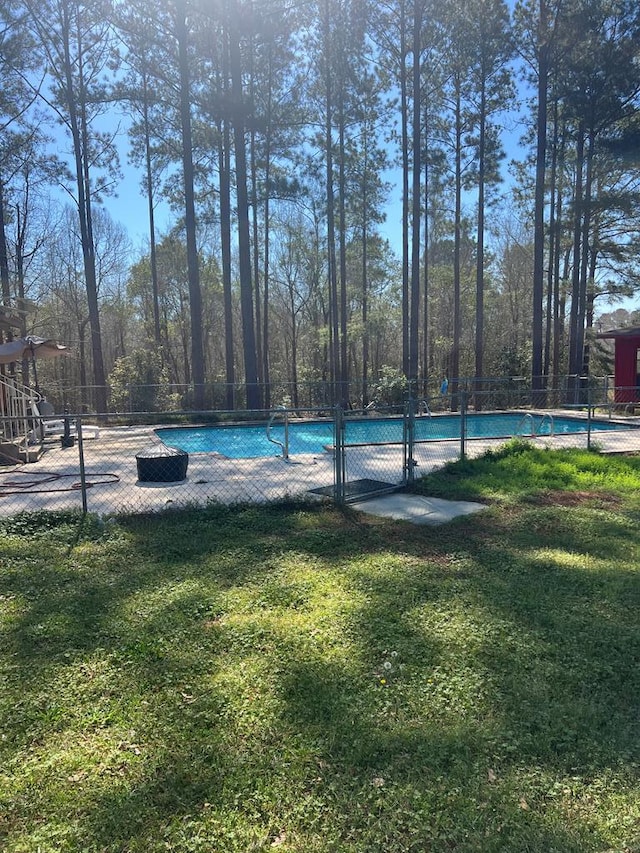 pool featuring a yard and fence