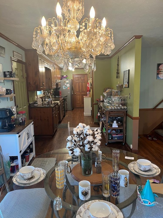 dining room with wood finished floors and crown molding