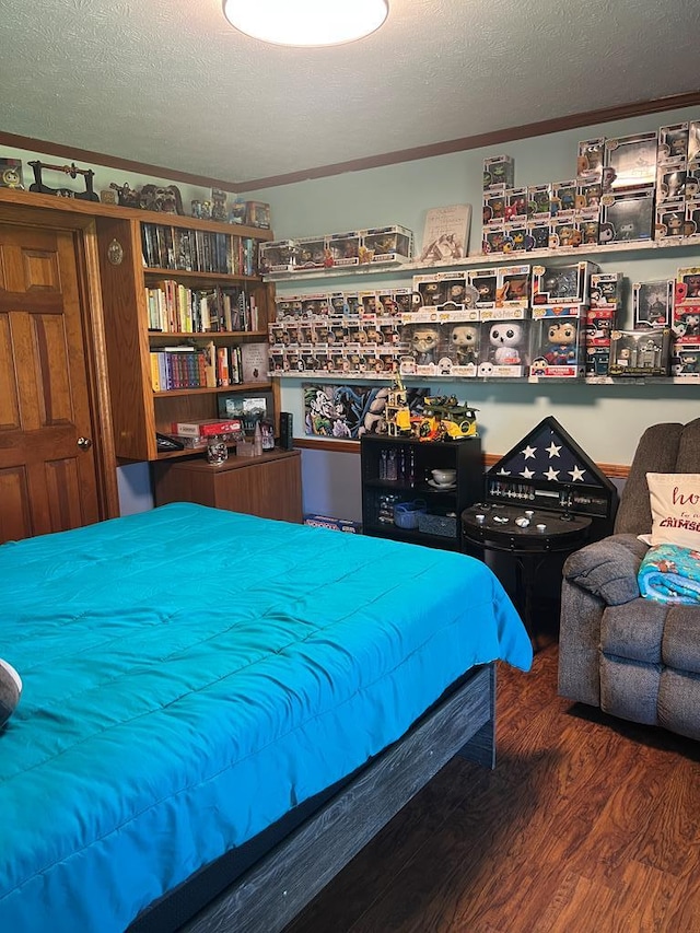 bedroom with wood finished floors and a textured ceiling