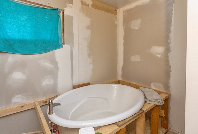 bathroom with a tub to relax in