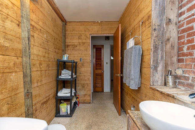 bathroom featuring wooden walls