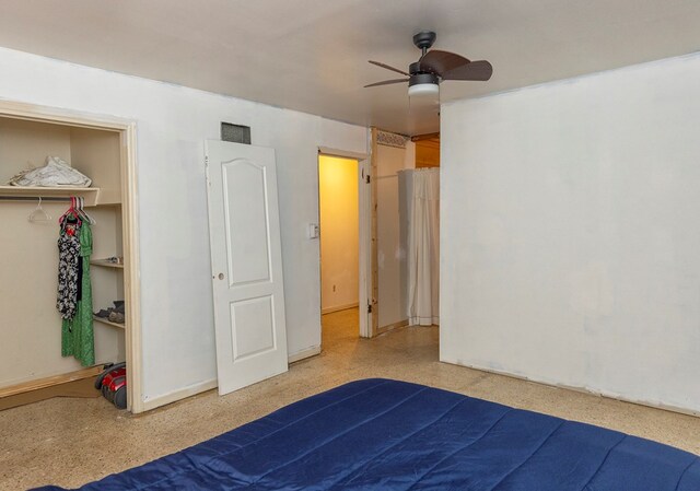 unfurnished bedroom featuring ceiling fan, a spacious closet, and a closet