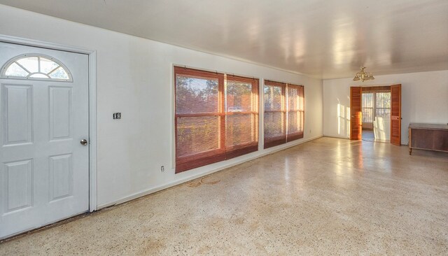 foyer entrance featuring a chandelier and plenty of natural light