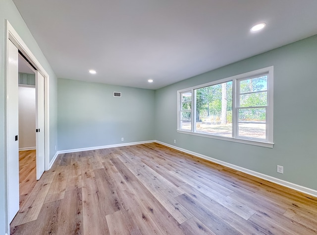 unfurnished room featuring a healthy amount of sunlight and light hardwood / wood-style flooring