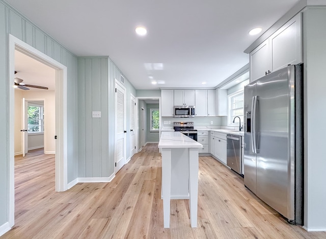 kitchen featuring a healthy amount of sunlight, stainless steel appliances, light hardwood / wood-style flooring, and sink