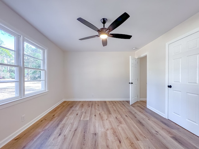 spare room featuring light wood-type flooring and ceiling fan