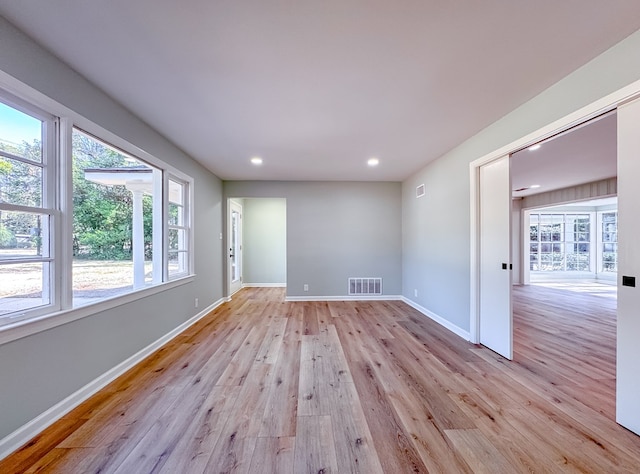 unfurnished room featuring plenty of natural light and light hardwood / wood-style flooring