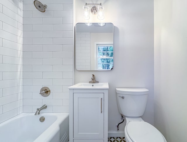 full bathroom featuring toilet, vanity, and tiled shower / bath