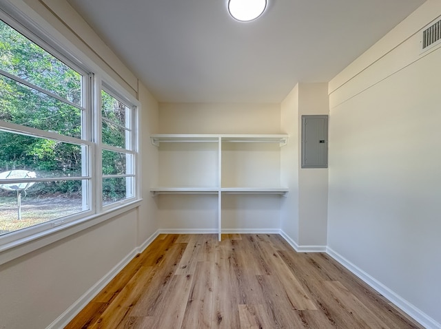 interior space with electric panel and light hardwood / wood-style floors