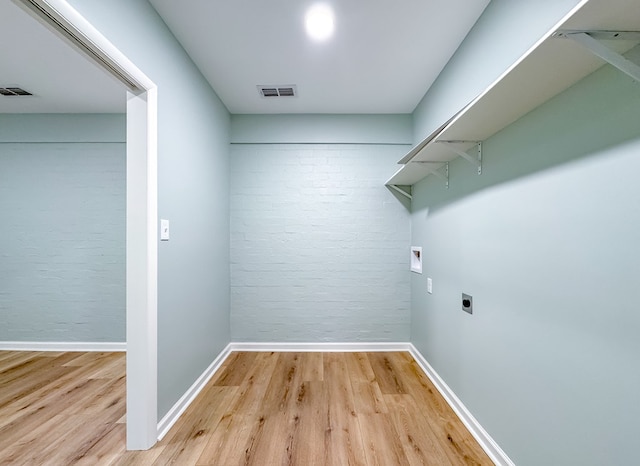 laundry room featuring washer hookup, light hardwood / wood-style flooring, and electric dryer hookup