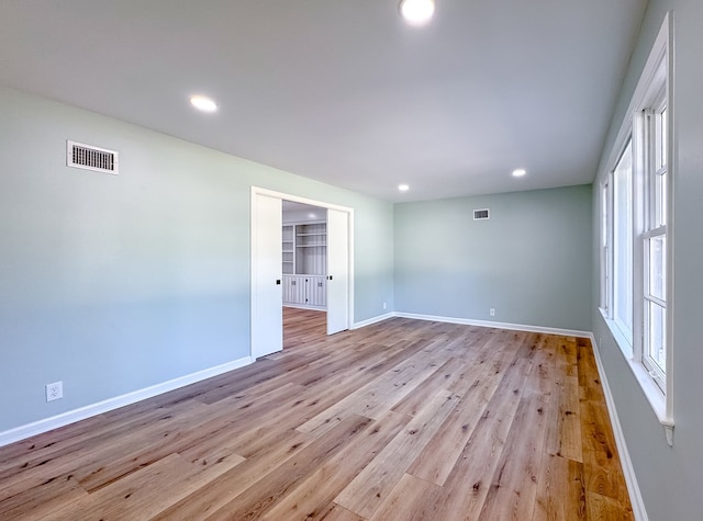 spare room featuring light wood-type flooring