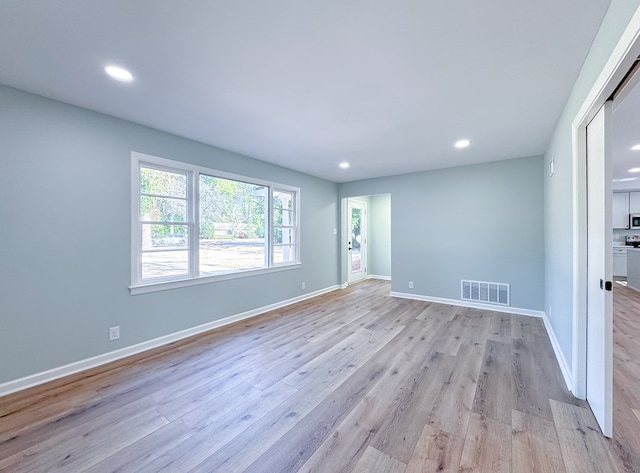 spare room featuring light wood-type flooring