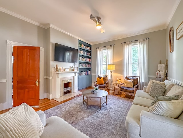 313 E Evans St, Bainbridge, GA 39817 - living room featuring wood finished floors, crown molding, a tile fireplace, and built in features