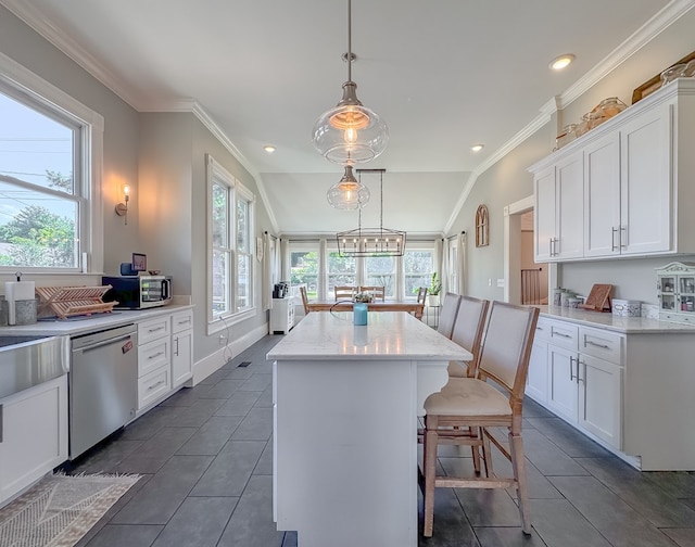 313 E Evans St, Bainbridge, GA 39817 - kitchen featuring stainless steel appliances, plenty of natural light, a center island, white cabinets, and ornamental molding