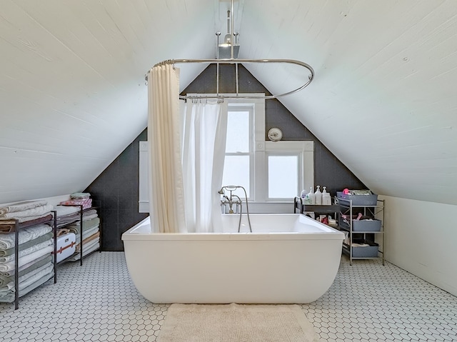 313 E Evans St, Bainbridge, GA 39817 - bathroom featuring vaulted ceiling, a freestanding tub, and curtained shower