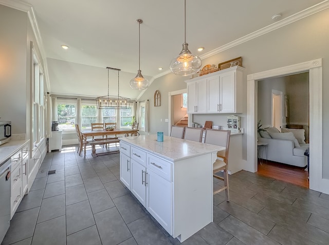 313 E Evans St, Bainbridge, GA 39817 - kitchen with white cabinetry, ornamental molding, a center island, light stone countertops, and recessed lighting
