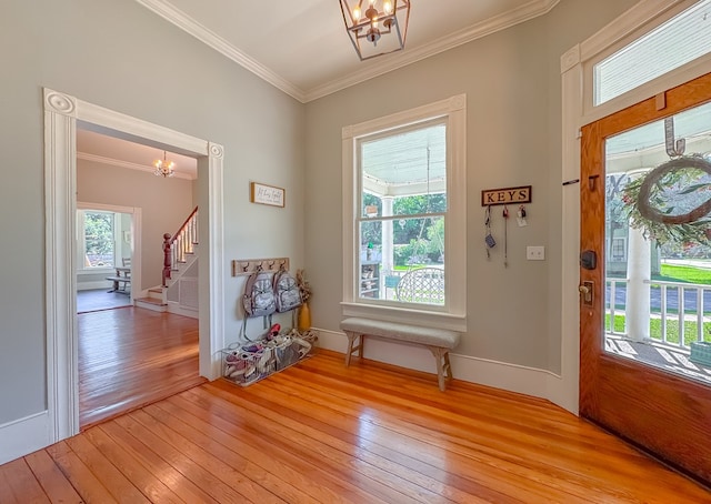 313 E Evans St, Bainbridge, GA 39817 - entryway with a chandelier, light wood-style floors, crown molding, stairs, and baseboards