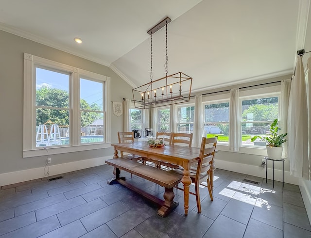 313 E Evans St, Bainbridge, GA 39817 - dining area with lofted ceiling, baseboards, crown molding, a chandelier, and dark tile patterned floors