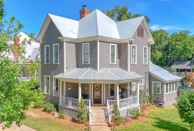 313 E Evans St, Bainbridge, GA 39817 - view of front of home featuring covered porch, a chimney, and metal roof