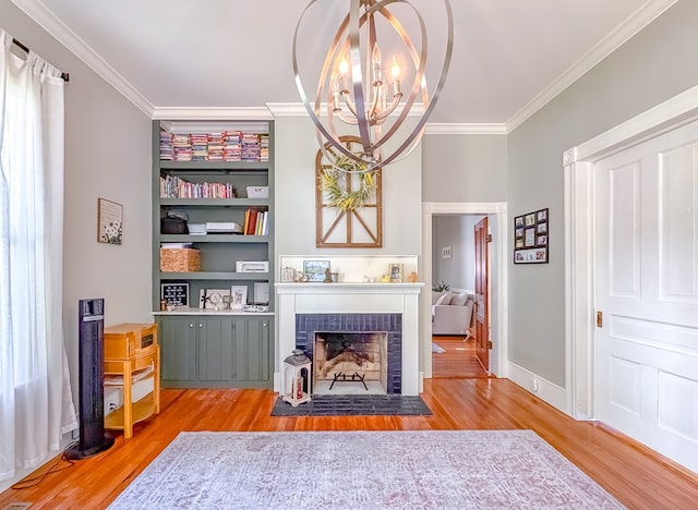 313 E Evans St, Bainbridge, GA 39817 - sitting room featuring crown molding, wood finished floors, a fireplace, and a chandelier