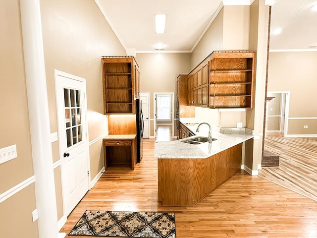 1870 SE Oakdale Rd, Cairo, GA 39828 - kitchen with open shelves, a sink, light wood-style flooring, a peninsula, and ornamental molding