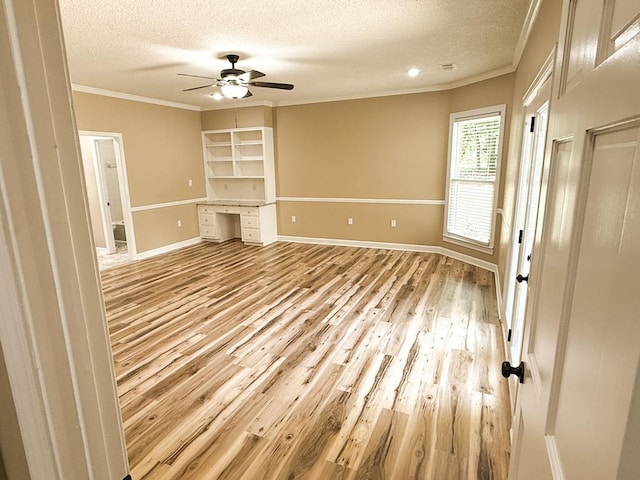 1870 SE Oakdale Rd, Cairo, GA 39828 - unfurnished living room with a ceiling fan, wood finished floors, a textured ceiling, baseboards, and ornamental molding