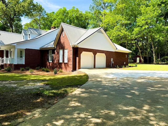 1870 SE Oakdale Rd, Cairo, GA 39828 - view of side of home featuring driveway, a porch, a yard, a garage, and brick siding