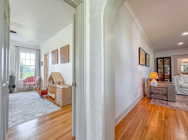 1267 Quincy Hwy, Attapulgus, GA 39815 - hall with crown molding, light wood-style floors, baseboards, arched walkways, and a chandelier