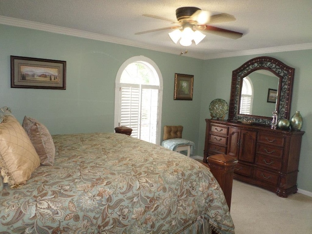 bedroom with crown molding, a ceiling fan, and light colored carpet