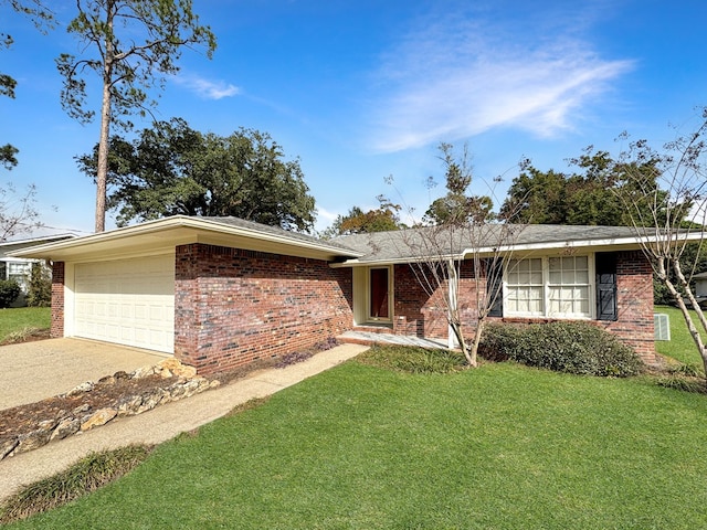 ranch-style home featuring a garage and a front lawn