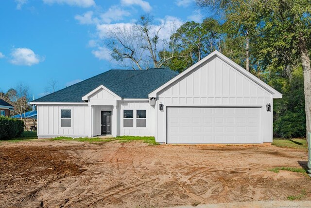 modern farmhouse style home featuring a garage