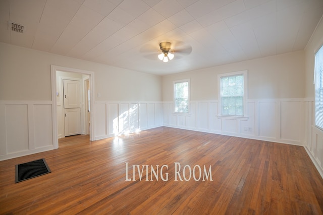 641 Evans, Bainbridge, GA 39819 - spare room with a decorative wall, hardwood / wood-style floors, a ceiling fan, and wainscoting