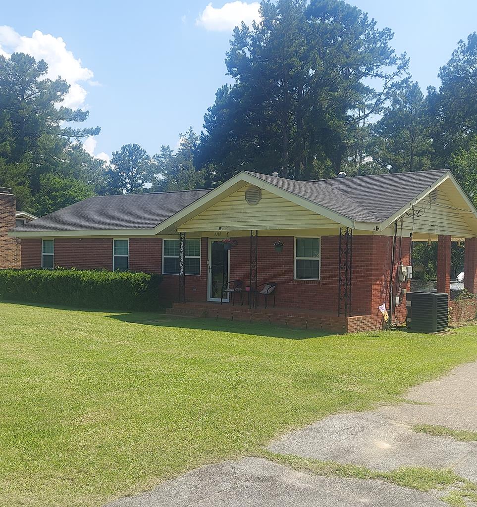 1310 Stone Ave, Cairo, GA 39828 - single story home featuring covered porch, a front lawn, and brick siding