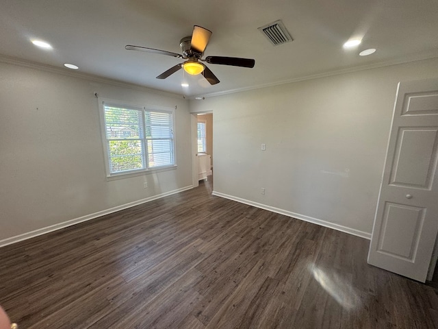 unfurnished room with ornamental molding, visible vents, and dark wood-type flooring