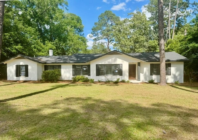 ranch-style house with a front yard and stucco siding