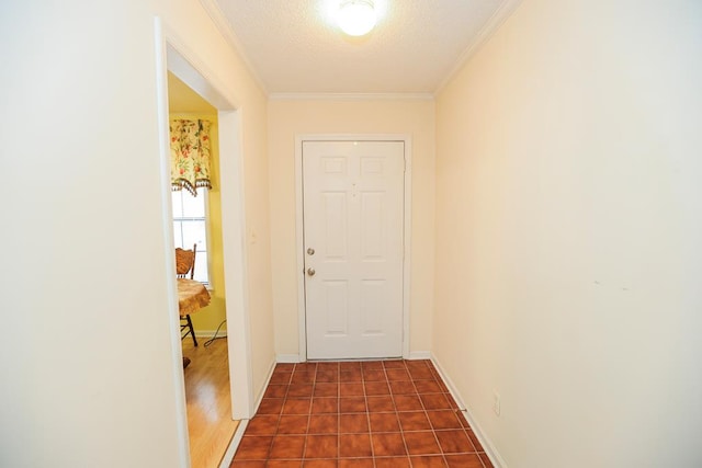 doorway to outside with baseboards, crown molding, and a textured ceiling